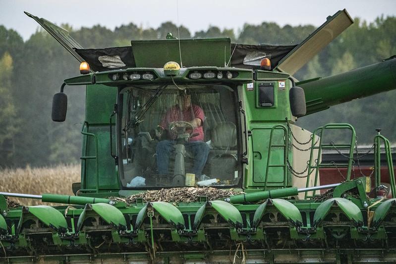 Man driving large farm equipment