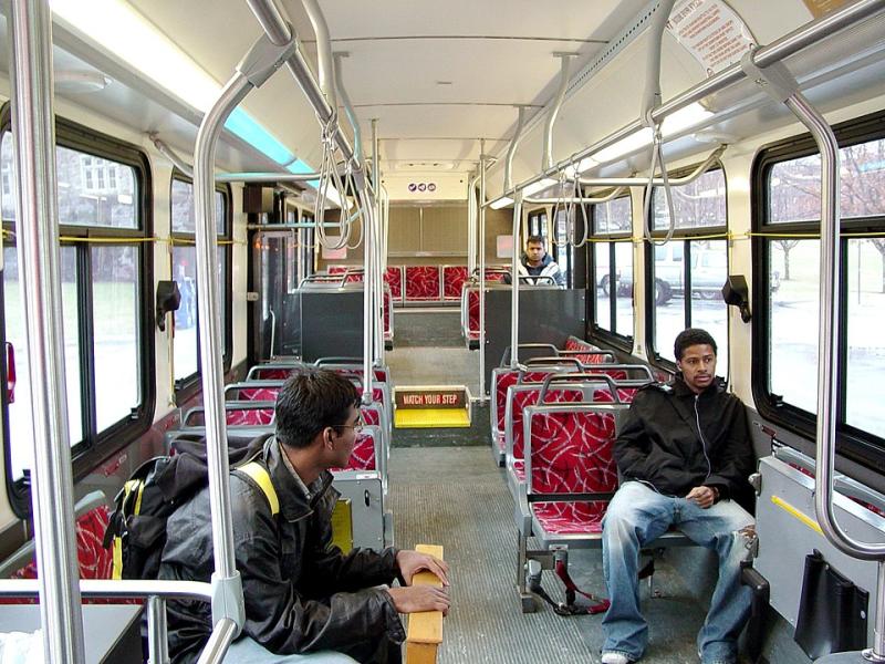 Two men siting in a bus.