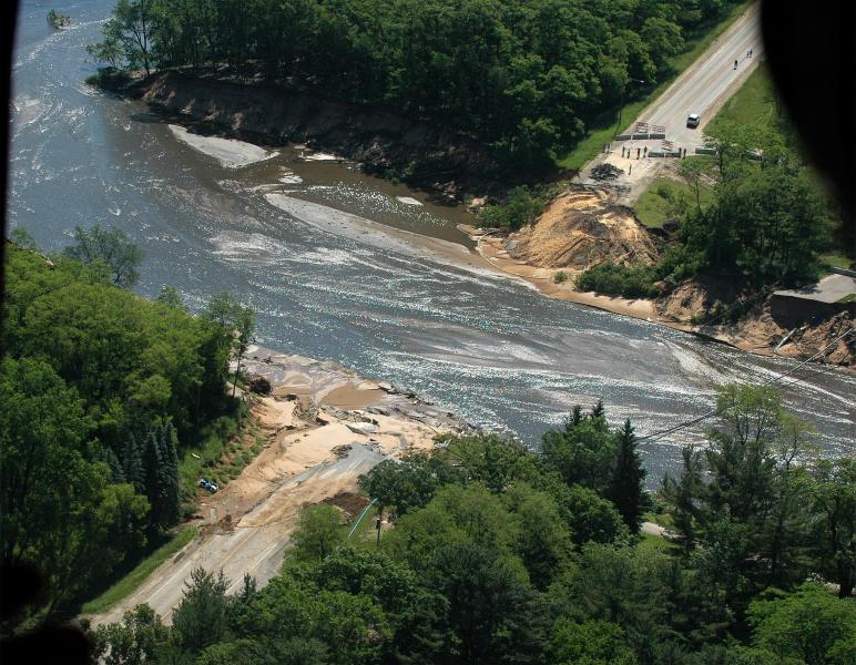 A road washed out by a flooded river