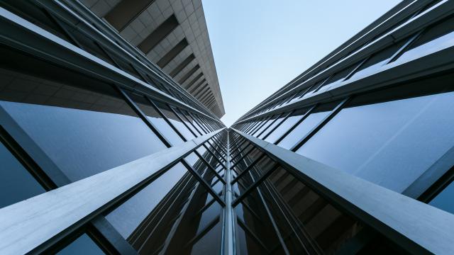 View looking up at a glass high rise building